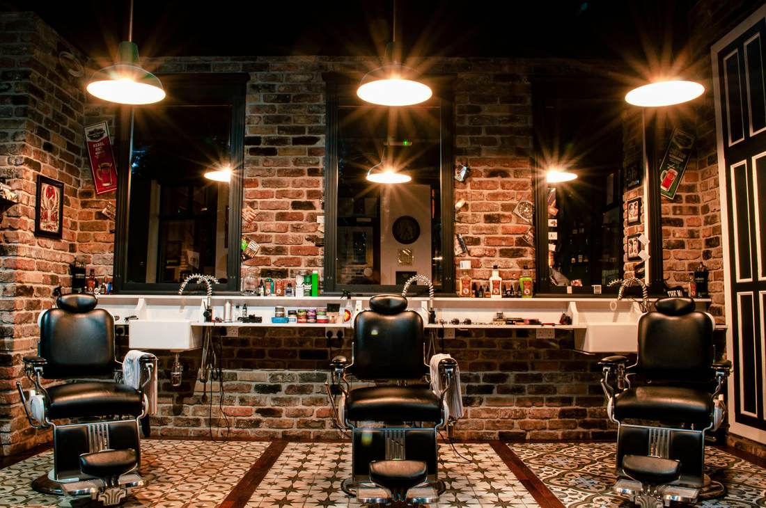 Inside the shop: chairs, brick, and warm light