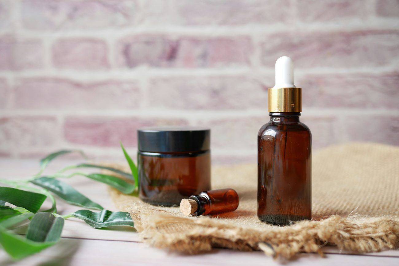 Amber glass serum bottles on the studio shelf